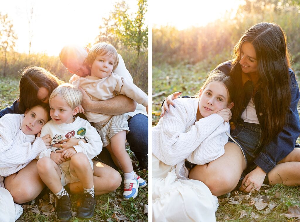 Family sitting close together on fallen leaves at sunset, with soft golden light and relaxed, natural poses.