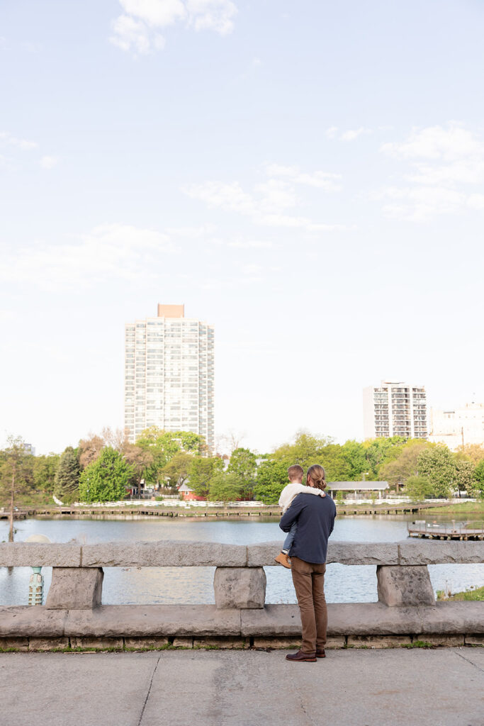 Father and son looking out across the pond at Lincoln Park Nature Boardwalk in Chicago.