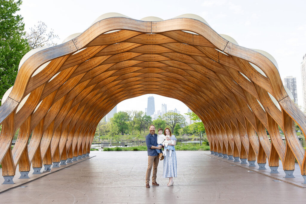 Family standing beneath the wooden pavilion at Lincoln Park Nature Boardwalk in Lincoln Park, Chicago